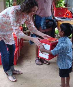 Joan Dorsey handing out solar lights to the children of Ganganhalli